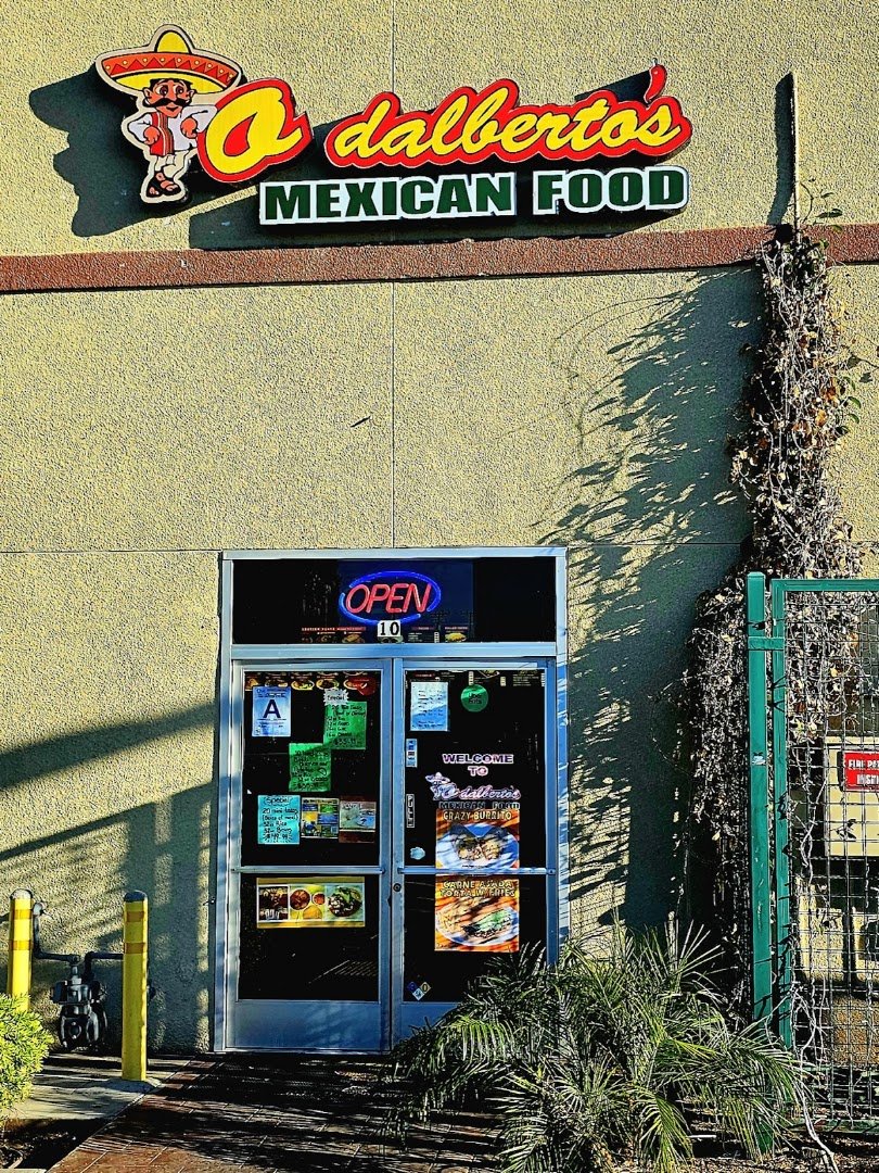 Mexican restaurant interior with colorful plates on tables.